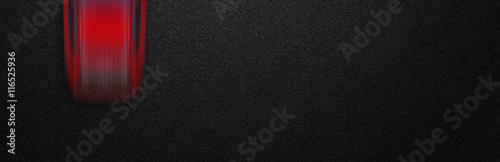 Smooth asphalt road and moving with high speed a red car. The texture of the tarmac, top view.