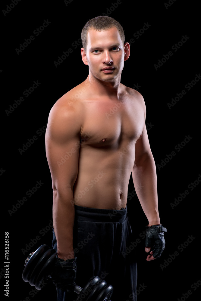 beautiful sexy bodybuilder with dumbbell on black background