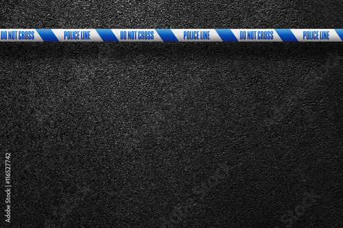 English white-blue police line in the background smooth asphalt road. Do not cross. The texture of the tarmac, top view.