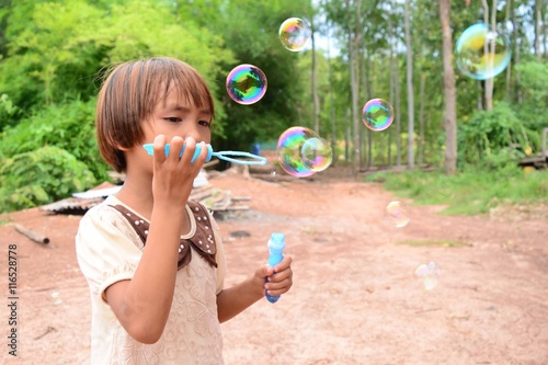 little girl play with bubbles