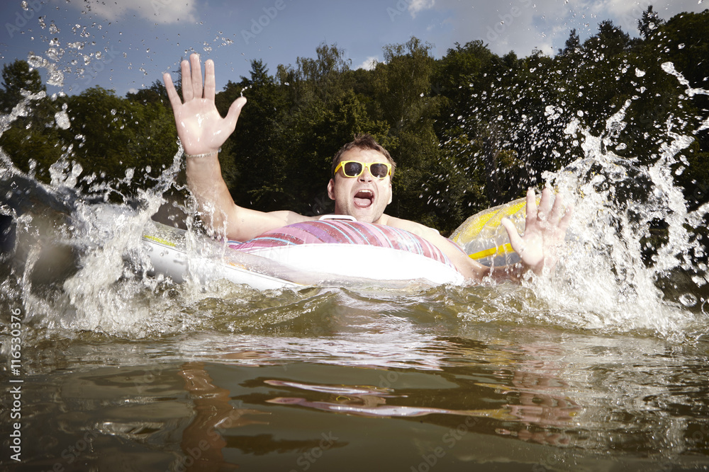 Fototapeta premium Funny man bathing in european lake in summer time