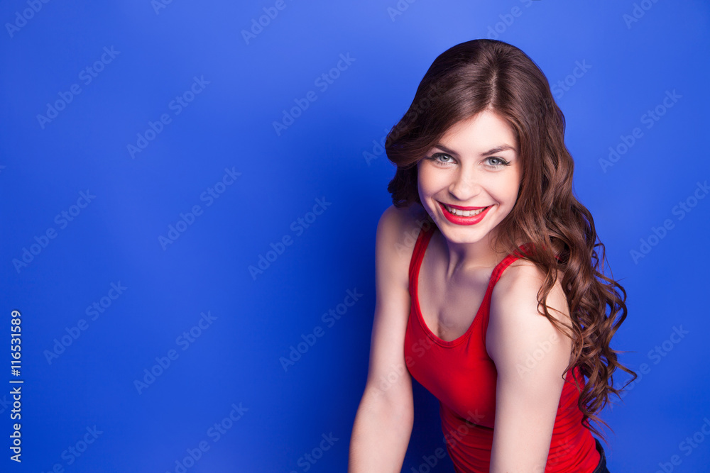 Attractive young brunette with red lips smiling at camera Attractive young brunette with red lips smiling at camera