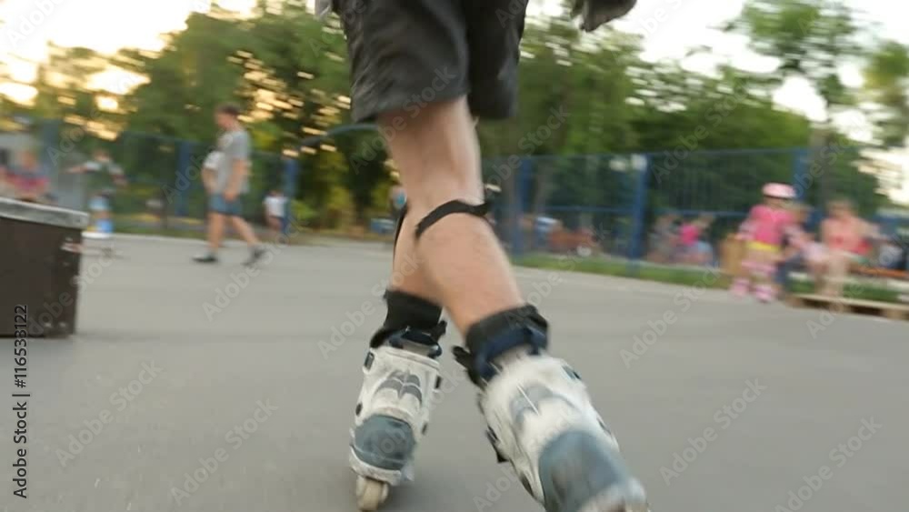 Rollerskater does various tricks in skate park