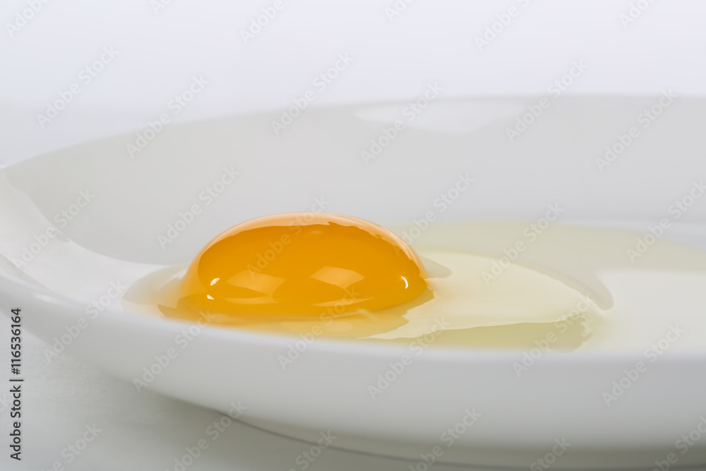 Yellow yolk close up shot on the plate Yellow yolk close up shot on the plate