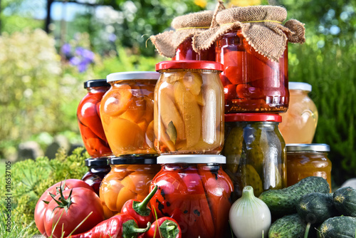 Jars of pickled vegetables and fruits in the garden