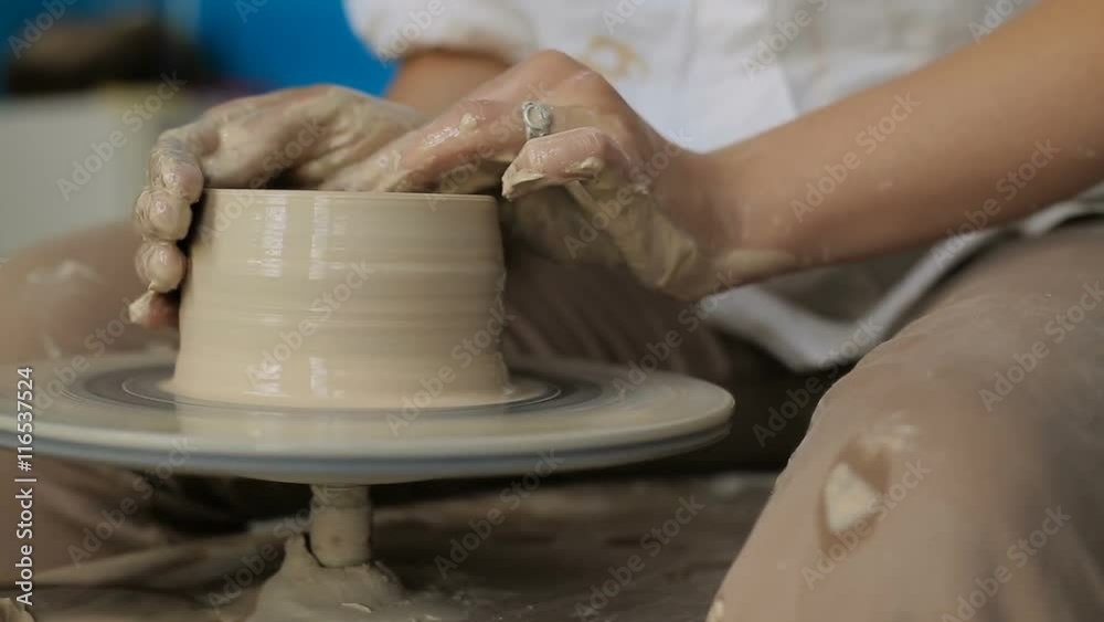 Hands working on pottery wheel Hands working on pottery wheel