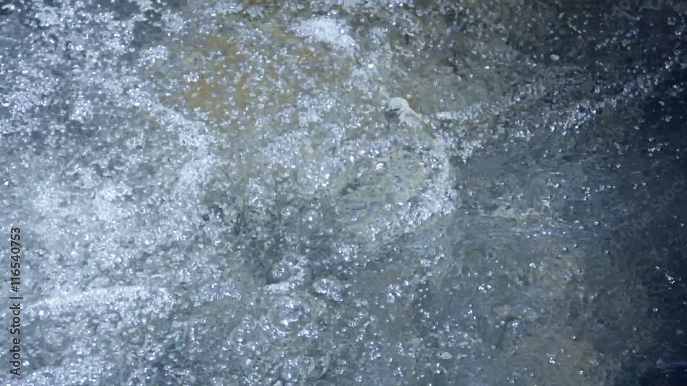 Video 1080p - Water is churning and frothing at the bottom of a waterfall. Bubbling and swirling are the visible results of the impact on the pool from the falling water. Background WITH SOUND Video 1080p - Water is churning and frothing at the bottom of a waterfall. Bubbling and swirling are the visible results of the impact on the pool from the falling water. Background WITH SOUND