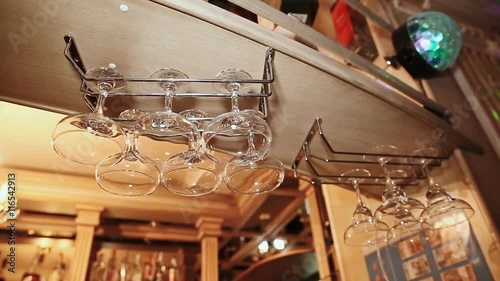 Empty glasses hang at the bar photo