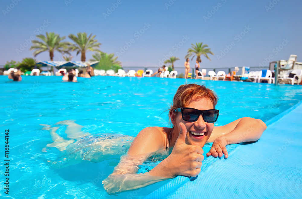  woman at the resort swimming in the pool