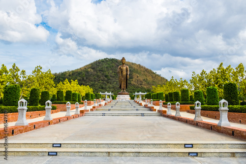 Giant golden buddha standing scenic in buddhist place at thipsukontharam temple, huai krachao, kanchanaburi, thailand photo