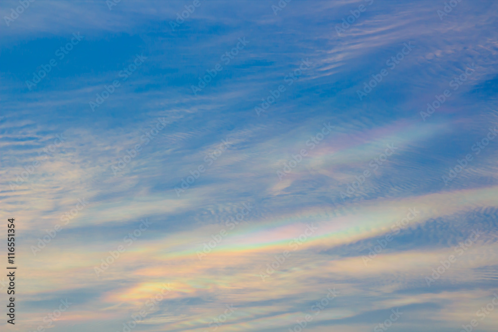 Colorful iridescent cloud, Beautiful Rainbow cloud. Blue sky at sunset, abstract background.