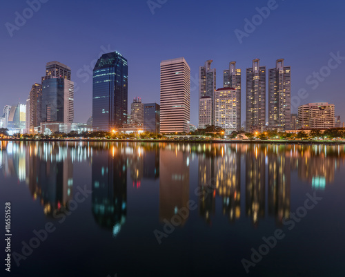 Benchakitti Park near r business district,Bangkok city with park at twilght with reflection of skyline, Bangkok,Thailand