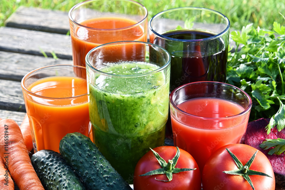 Glasses with fresh organic detox juices in the garden Glasses with fresh organic detox juices in the garden