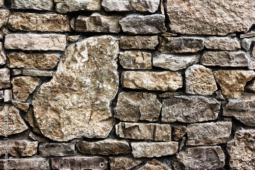 Background texture of a wall built of stone  toned photo