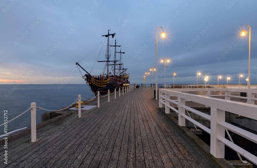 Pier and ships in Sopot at sunset, Poland.