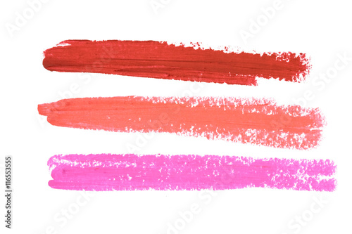 Smudged lipsticks isolated on white background