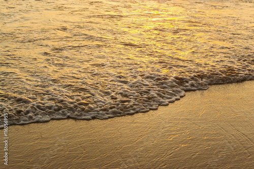 Wave of the sea and sand beach sunset