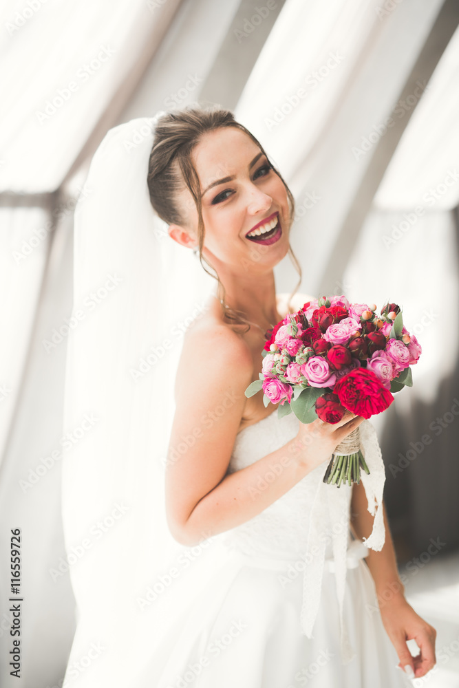 Wonderful bride with a luxurious white dress posing in the old town Wonderful bride with a luxurious white dress posing in the old town
