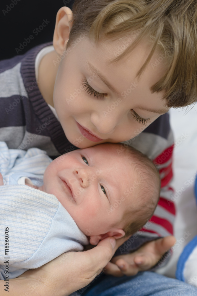 Curious Boy holding his little brother Curious Boy holding his little brother