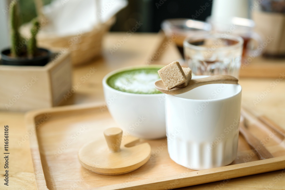 Hot green tea set on a wooden table in a coffeshop Hot green tea set on a wooden table in a coffeshop