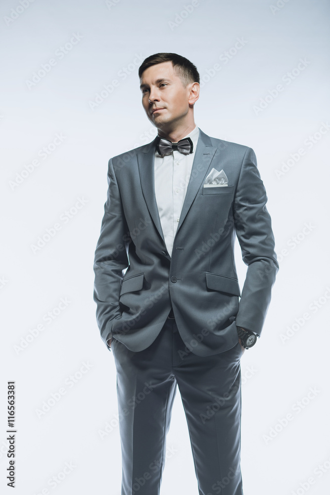 Fototapeta premium Portrait of a elegant handsome business man on white background