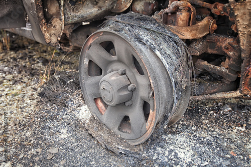 Close up of the remains of a car wheel after it was burnt. photo