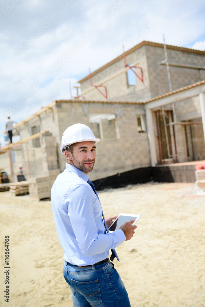 portrait of handsome young man architect on a building industry construction site