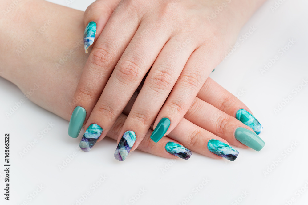 Closeup of woman hands with colorful nails Closeup of woman hands with colorful nails