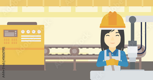 Woman working on industrial drilling machine.