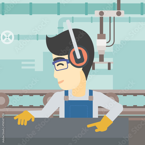 Man working on metal press machine.