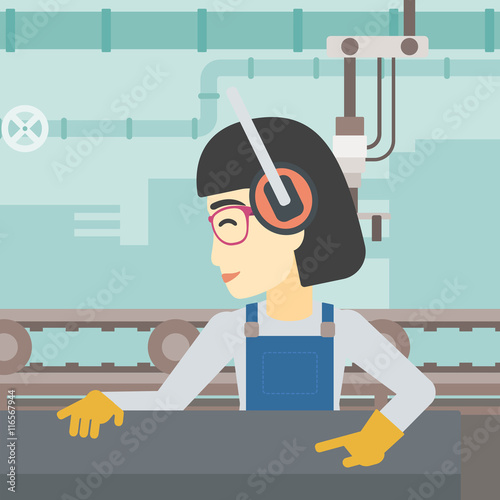 Woman working on metal press machine.