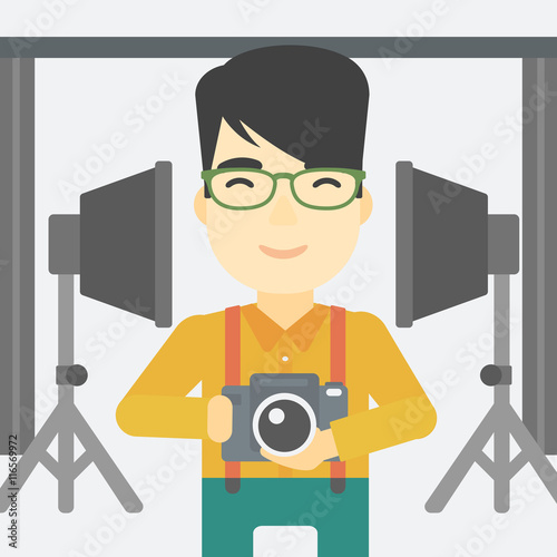 Photographer with camera in photo studio.