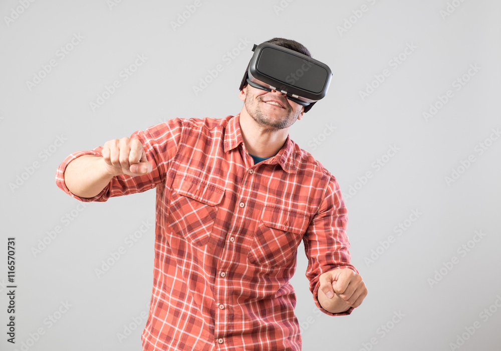 Man with virtual reality glasses paying bike simulator Man with virtual reality glasses paying bike simulator