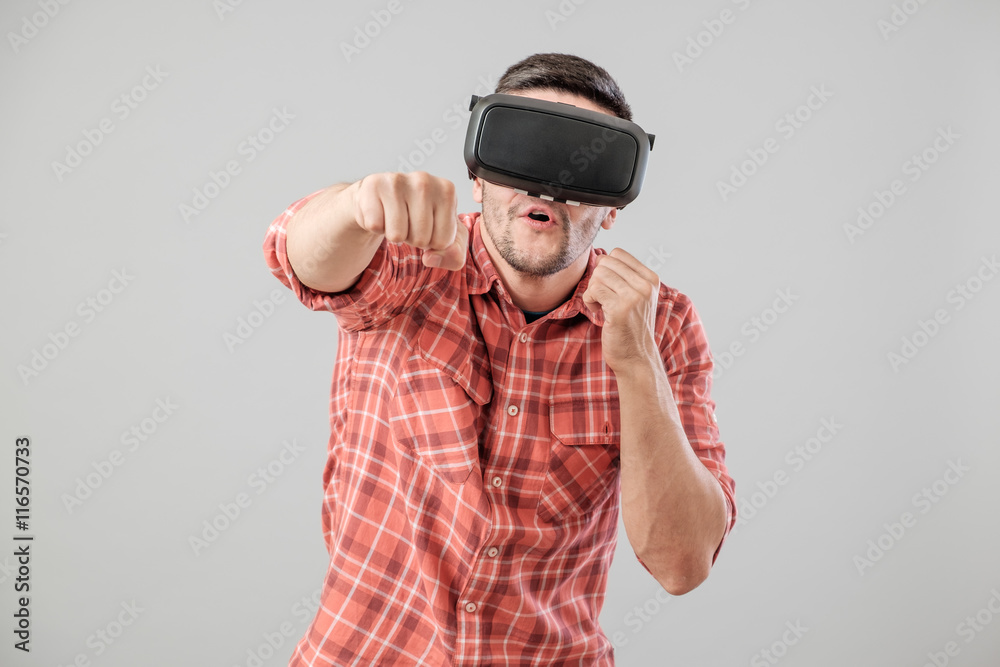 Man in fighter stand with virtual reality glasses Man in fighter stand with virtual reality glasses