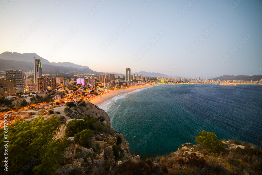 View of the coastline in Benidorm at sunset with city lights
