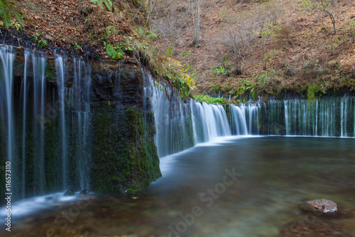 Shiraito Waterfall in autumn season , is located in the forests north of downtown Karuizawa , Japan