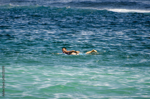 Man swimming with boogie board. photo