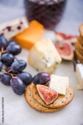 cheese board with grapes,wine,fig and olives