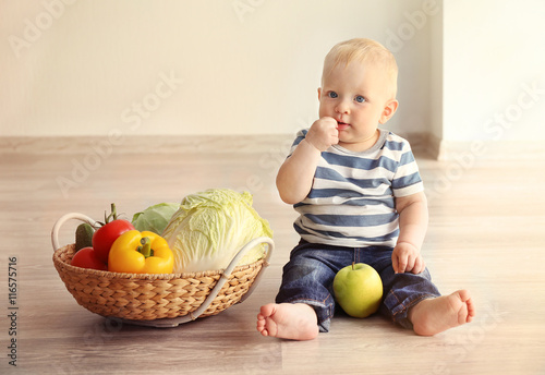 Cute baby and fresh vegetab...