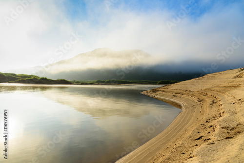 Fototapeta Naklejka Na Ścianę i Meble -  curve river with mountain cloudy fog