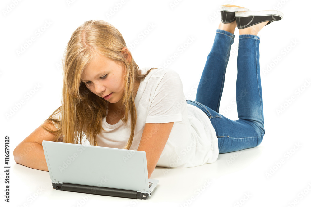 Young girl lying on the floor using laptop over white background Stock ...