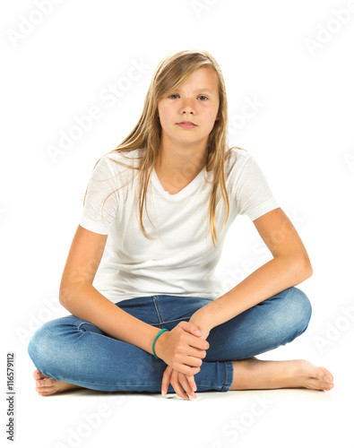 Young girl sitting with white t-shirt and blue jeans over white