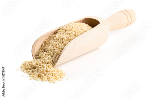 Natural brown uncooked rice in wooden scoop