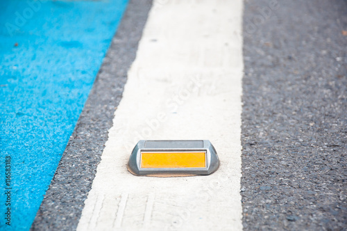 the Close up of reflector or stud on asphalt road
