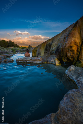 Woman relaxes in Travertine Hot Springs California USA Vertical Composition with copy space