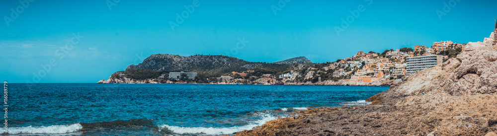 Panoramic nature scene with ocean and rocky beach