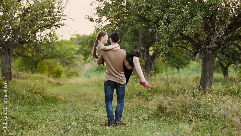 man turns his girlfriend in his arms man turns his girlfriend in his arms