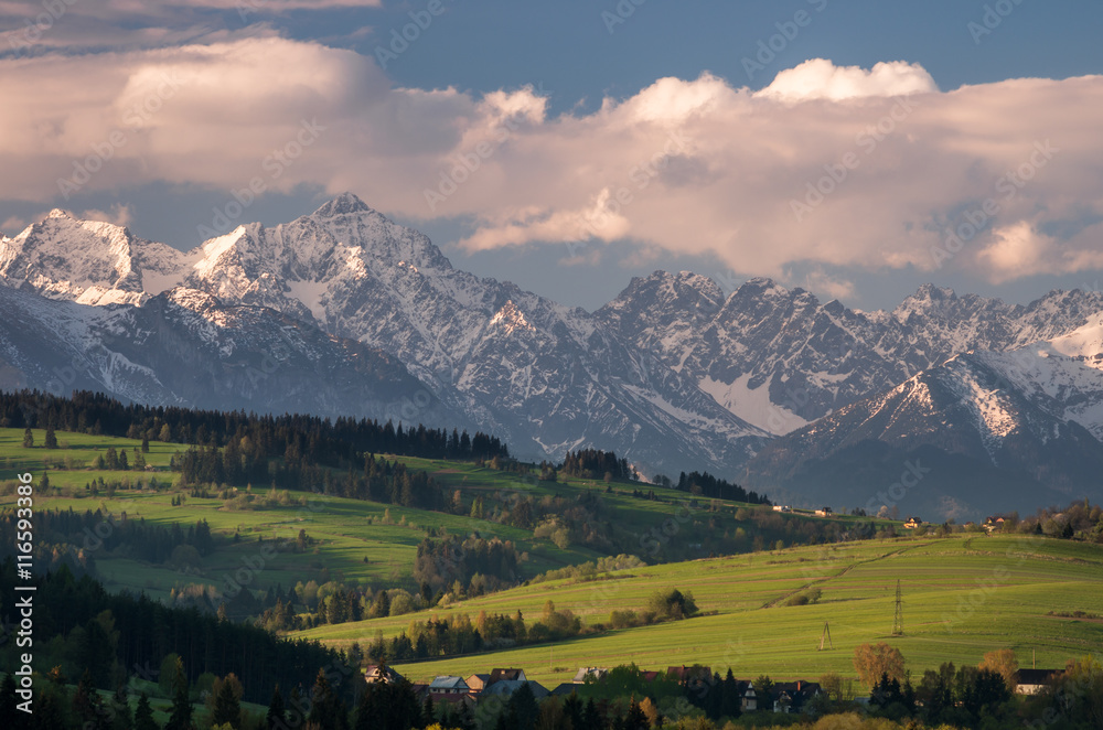 Beautiful spring panorama of Tatra mountains and green hills
