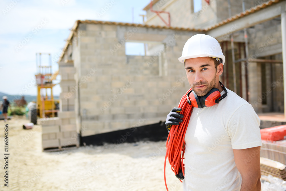 portrait of handsome construction worker on a building industry construction site portrait of handsome construction worker on a building industry construction site