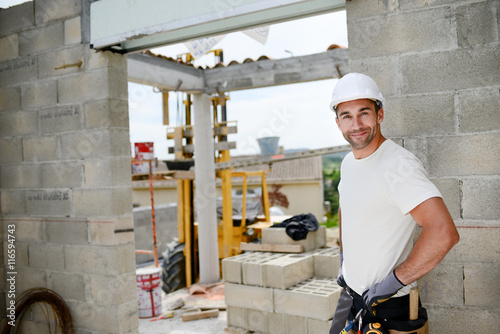 portrait of handsome construction worker on a building industry construction site photo